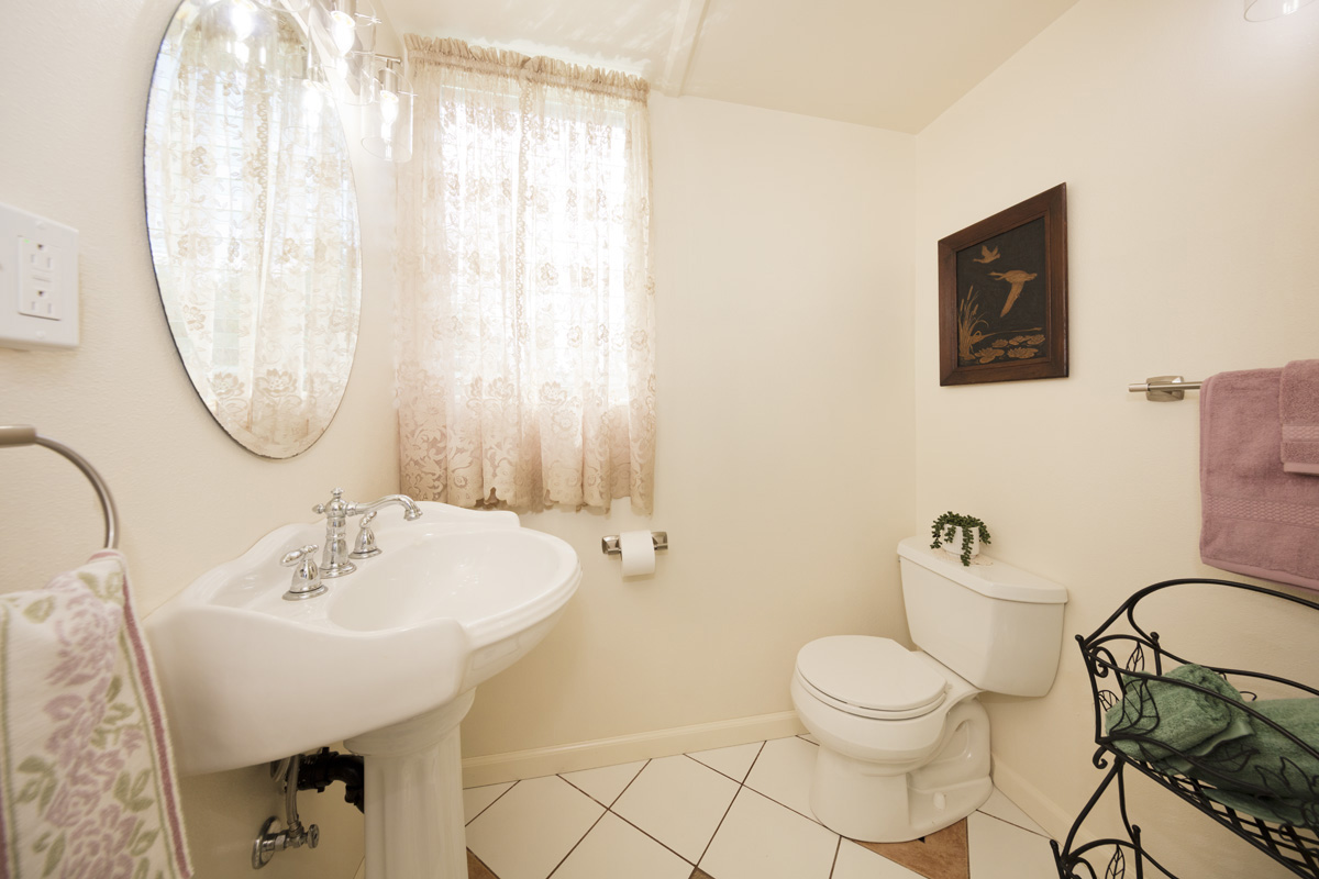 11-3545 Pikake Street Mountain View, HI 96771 - Photo 11 of 30 a bathroom with a toilet sink and mirror