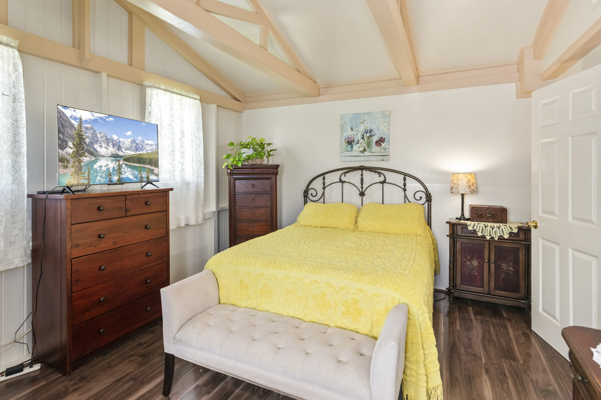 11-3545 Pikake Street Mountain View, HI 96771 - Photo 14 of 30 a bed sitting in a bedroom next to a window with dresser