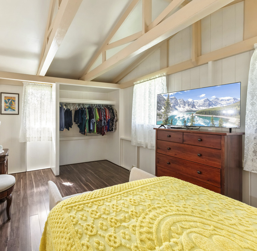 11-3545 Pikake Street Mountain View, HI 96771 - Photo 15 of 30 a bedroom with a bed and a flat screen tv