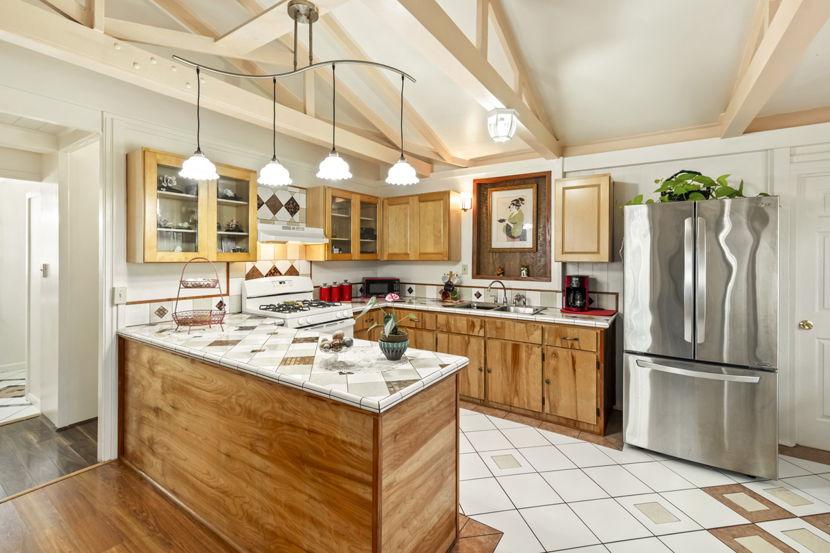 11-3545 Pikake Street Mountain View, HI 96771 - Photo 5 of 30 a kitchen with a sink a refrigerator and cabinets