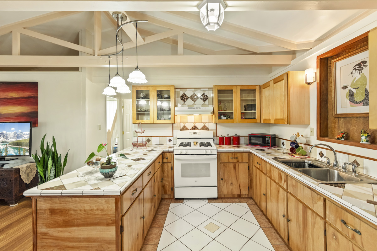 11-3545 Pikake Street Mountain View, HI 96771 - Photo 9 of 30 a kitchen with a sink stove and cabinets