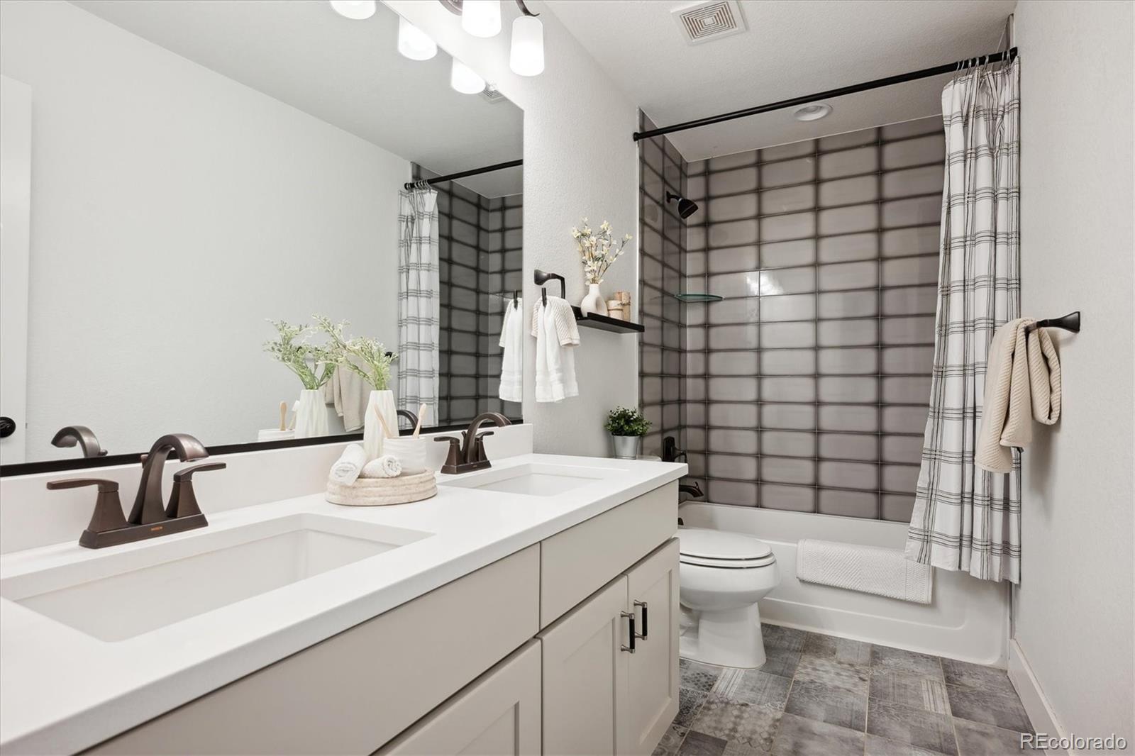 12841 Red Rosa Circle Parker, CO 80134 - Photo 19 of 29 a bathroom with a sink a toilet and shower