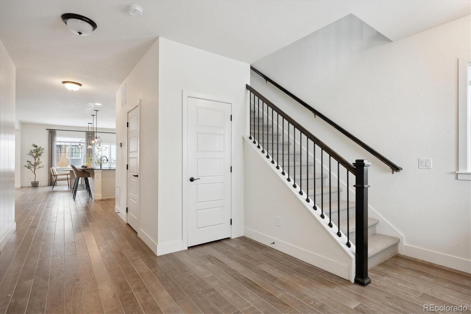 12841 Red Rosa Circle Parker, CO 80134 - Photo 2 of 29 a view of a hallway with wooden floor and stairs