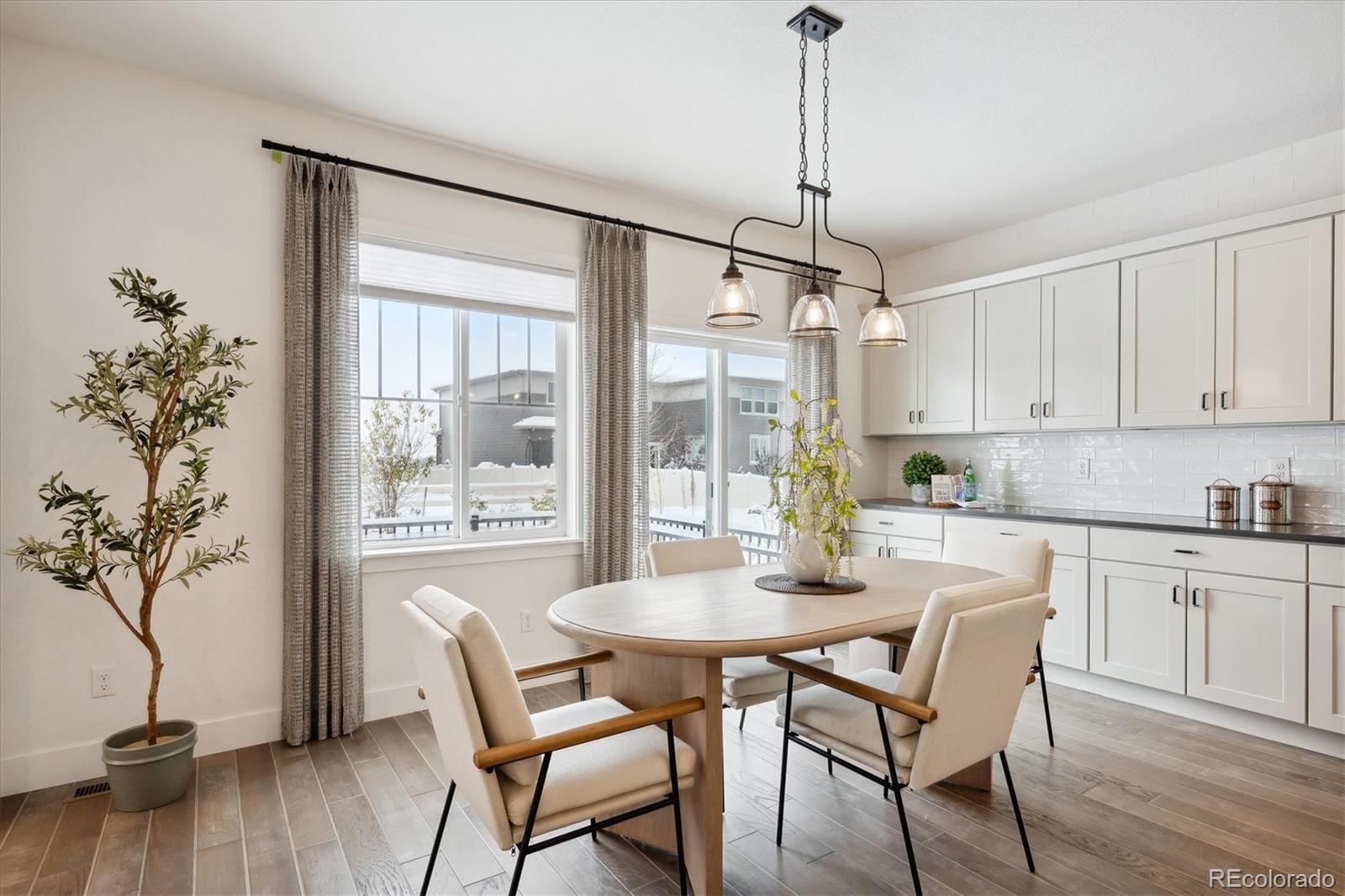 12841 Red Rosa Circle Parker, CO 80134 - Photo 7 of 29 a dining room with furniture wooden floor a chandelier