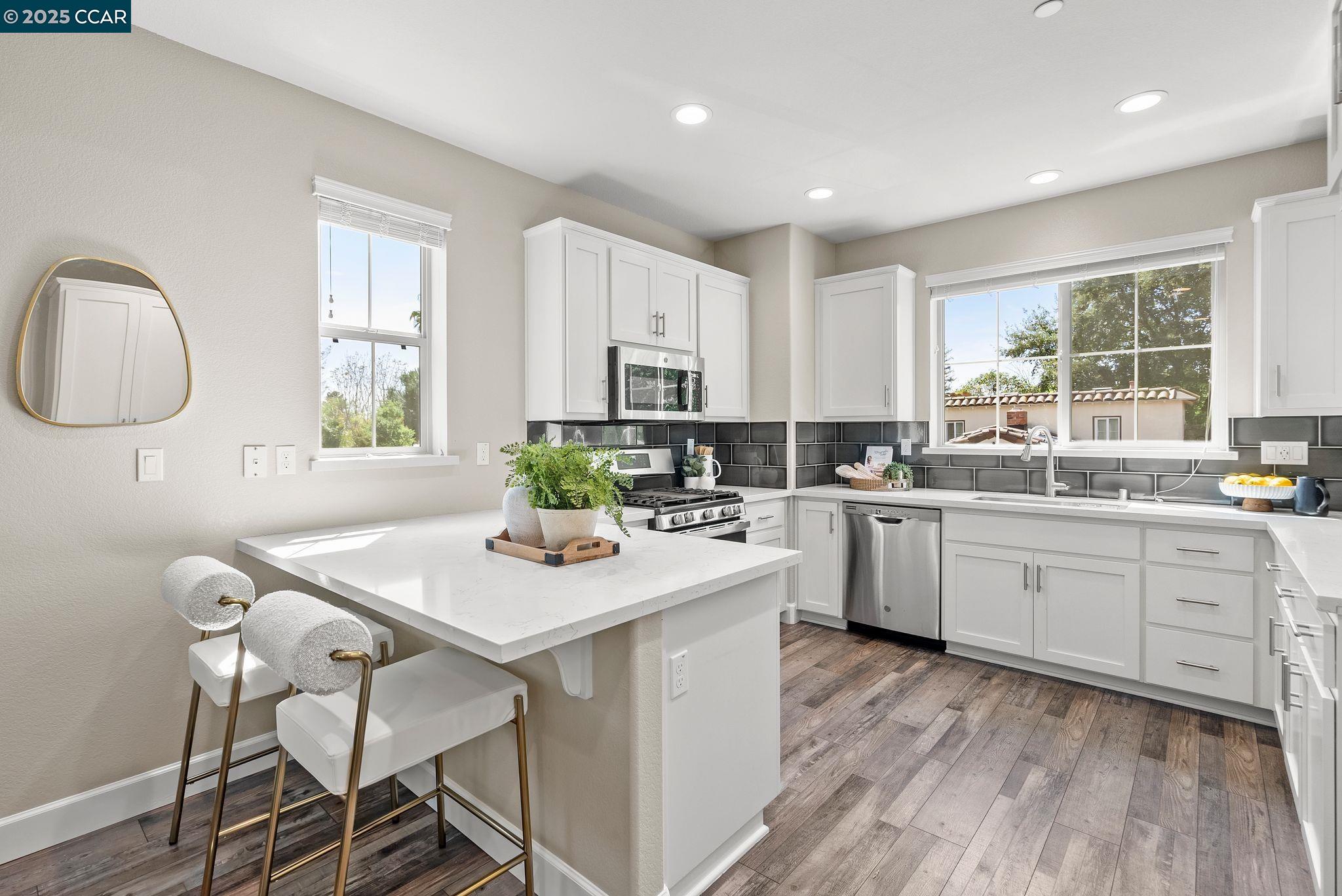 a kitchen with white cabinets stove and white appliances