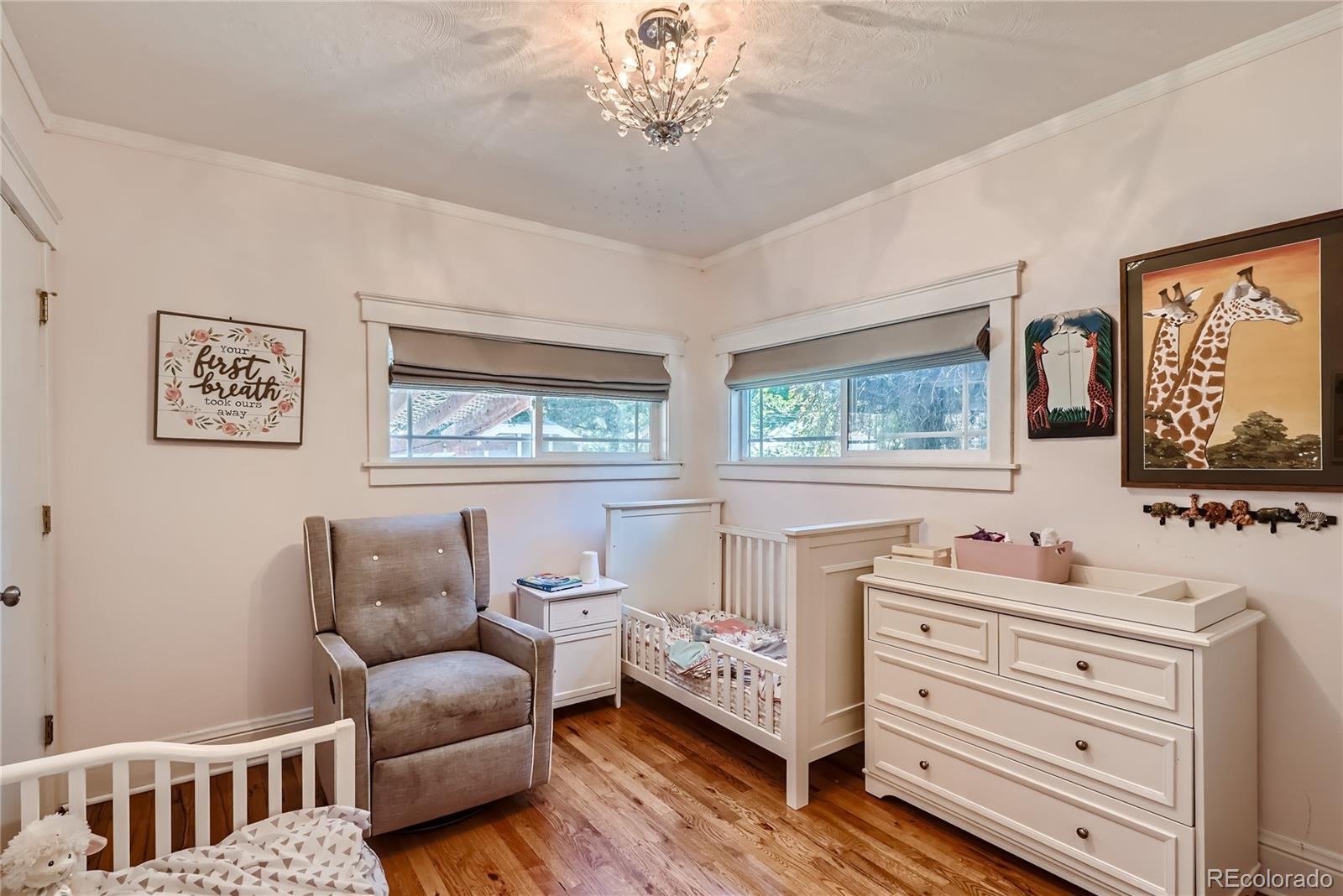 954 Monroe Street Denver, CO 80206 - Photo 15 of 28 a bedroom with a bed wooden floor and window
