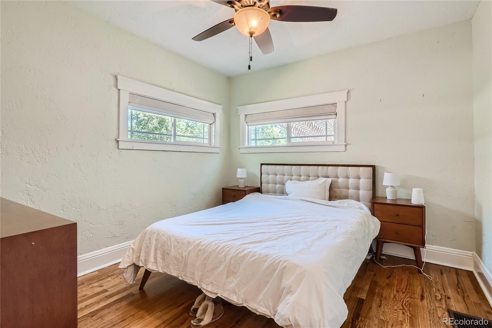 954 Monroe Street Denver, CO 80206 - Photo 17 of 28 a bedroom with a bed and a chandelier