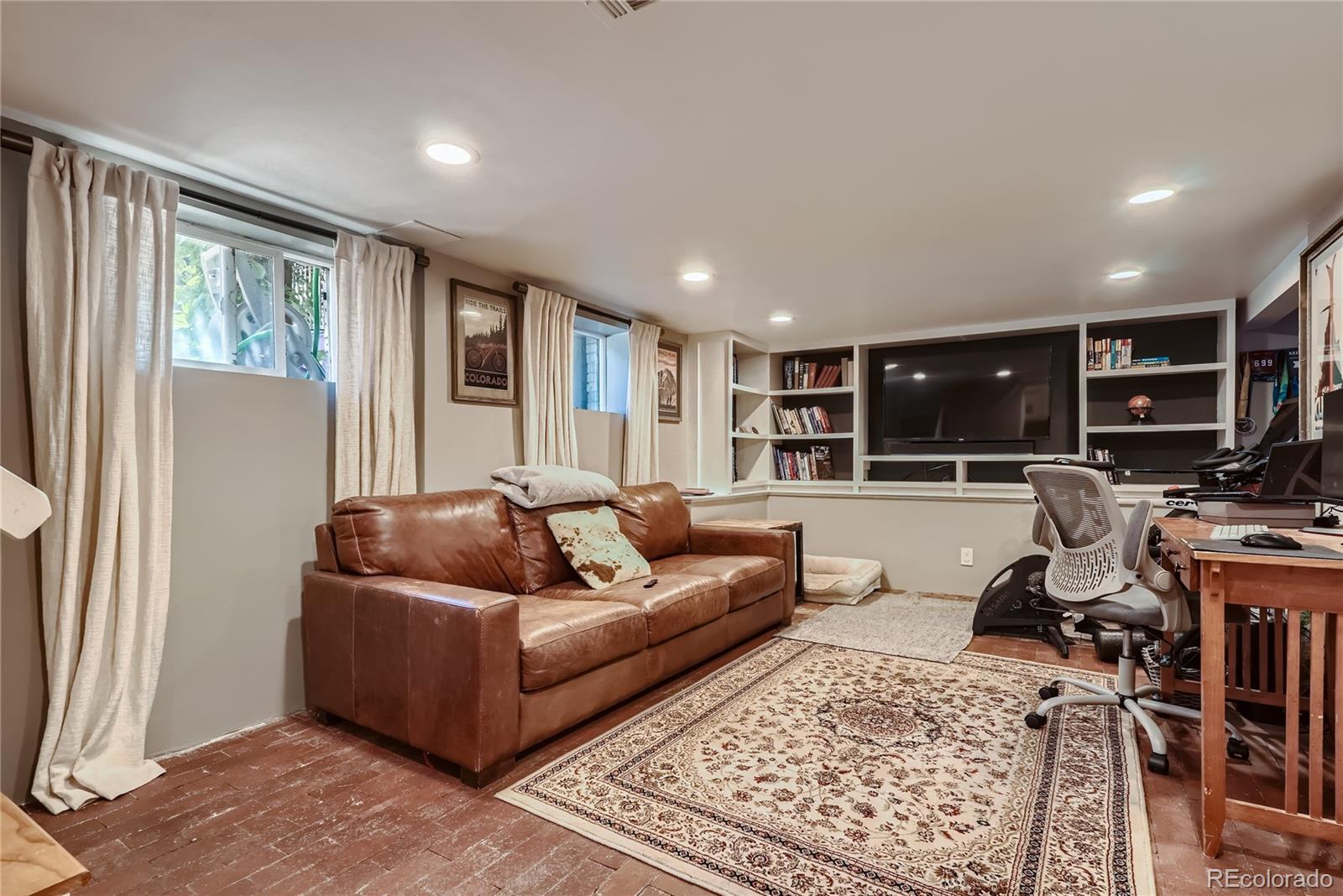 954 Monroe Street Denver, CO 80206 - Photo 19 of 28 a living room with furniture and a flat screen tv