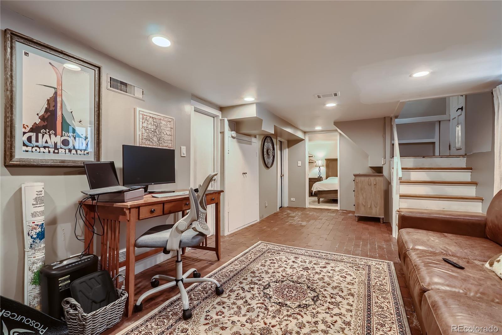 954 Monroe Street Denver, CO 80206 - Photo 20 of 28 a view of a livingroom with furniture and a flat screen tv