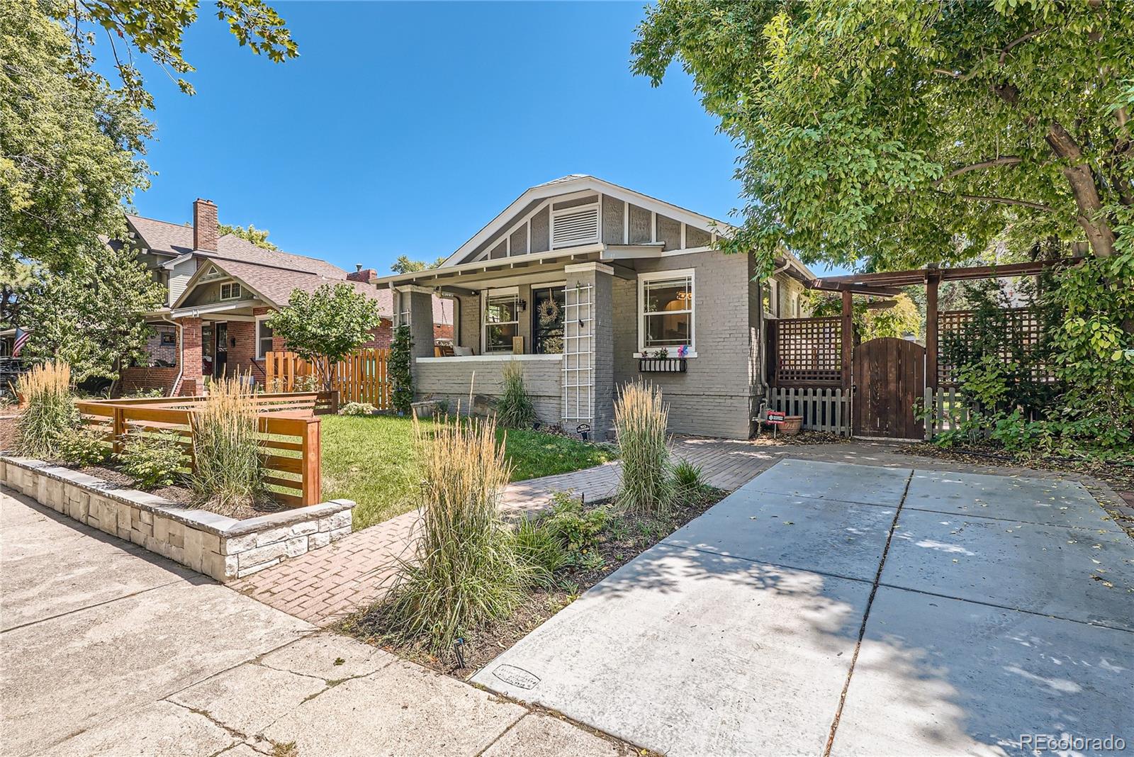 954 Monroe Street Denver, CO 80206 - Photo 2 of 28 a front view of a house with a garden