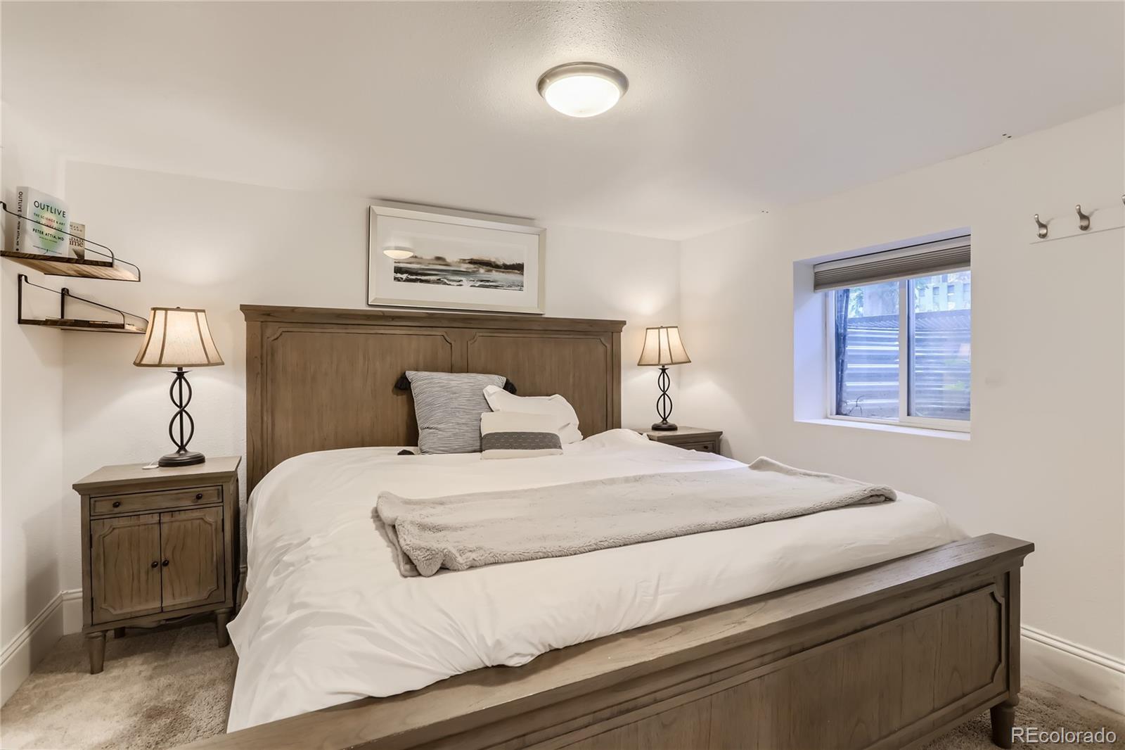 954 Monroe Street Denver, CO 80206 - Photo 21 of 28 a bedroom with a bed and a night stand