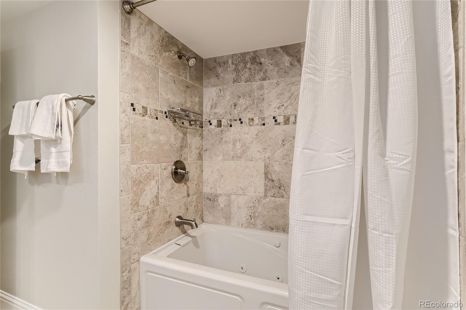 954 Monroe Street Denver, CO 80206 - Photo 24 of 28 a bathroom with a bathtub