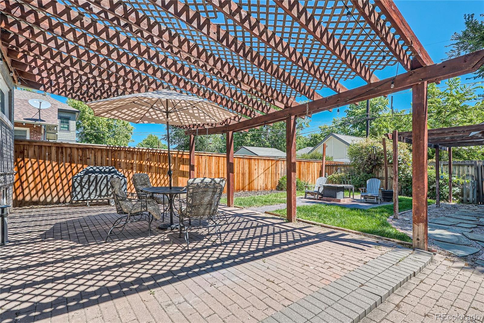 954 Monroe Street Denver, CO 80206 - Photo 25 of 28 a view of a roof deck with wooden floor barbeque grill with a table and chairs
