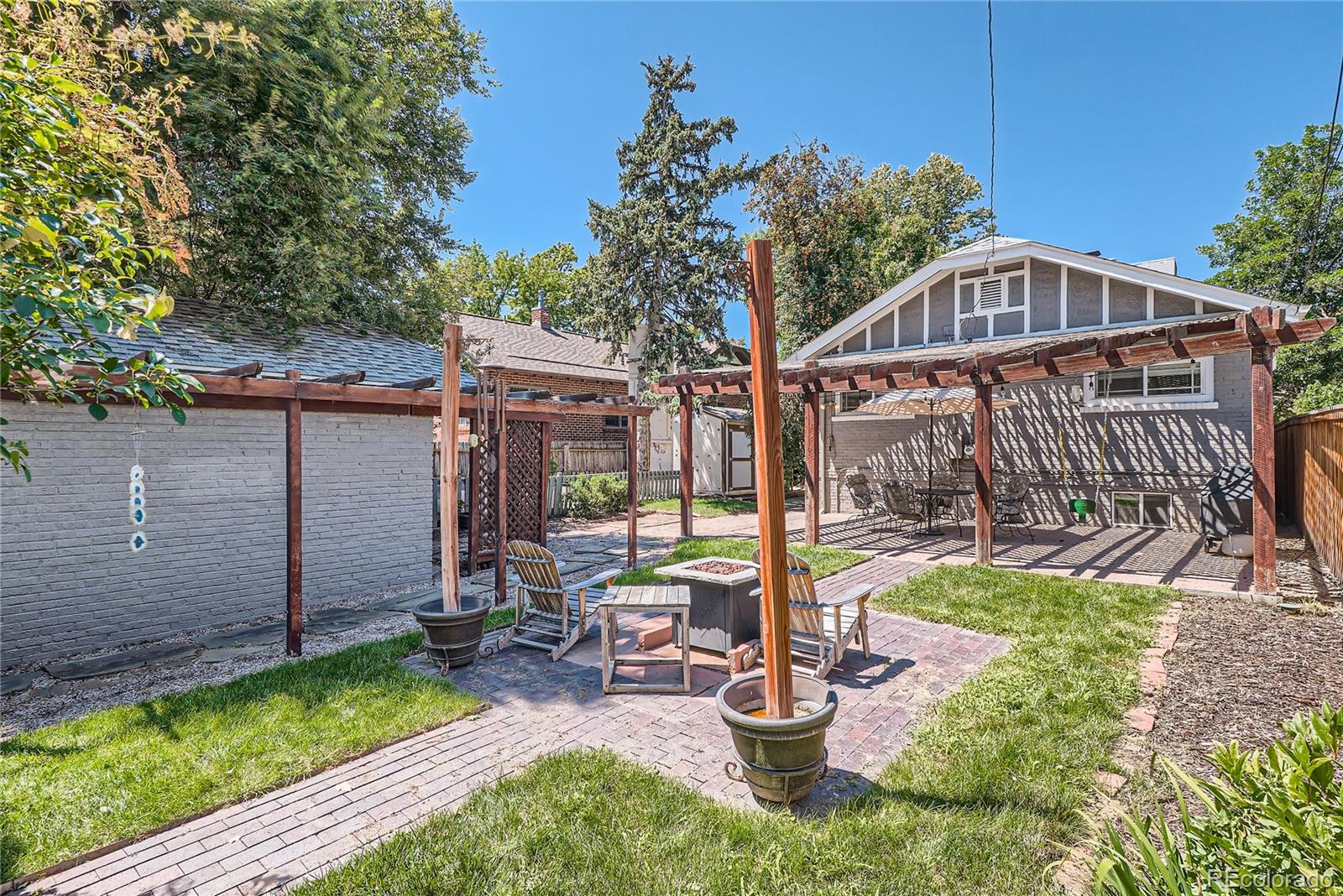 954 Monroe Street Denver, CO 80206 - Photo 26 of 28 a view of a chair and tables in backyard of the house