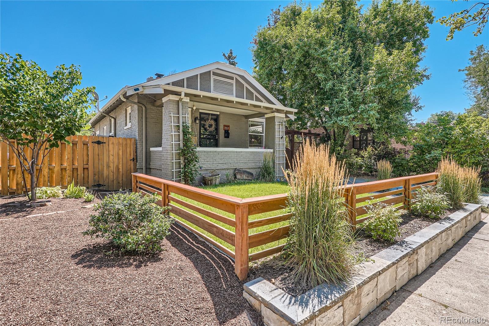 954 Monroe Street Denver, CO 80206 - Photo 3 of 28 a front view of a house with garden