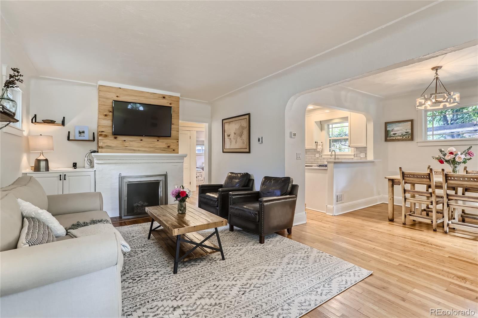 954 Monroe Street Denver, CO 80206 - Photo 7 of 28 a living room with furniture a rug and a fireplace
