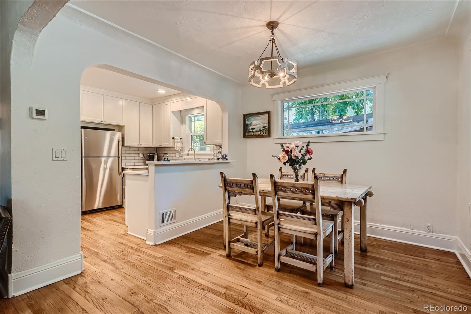 954 Monroe Street Denver, CO 80206 - Photo 9 of 28 a view of a dining room with furniture window and wooden floor