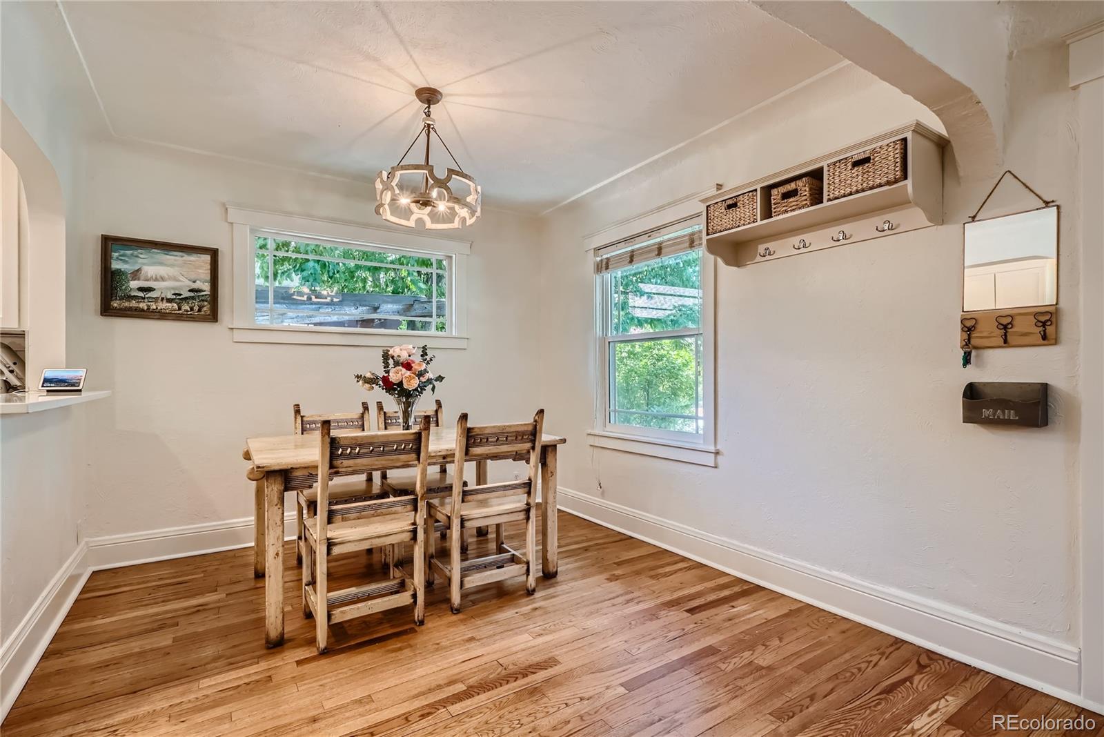 954 Monroe Street Denver, CO 80206 - Photo 10 of 28 a view of a dining room with furniture window and wooden floor