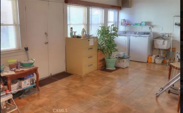 a room with painting and a potted plant