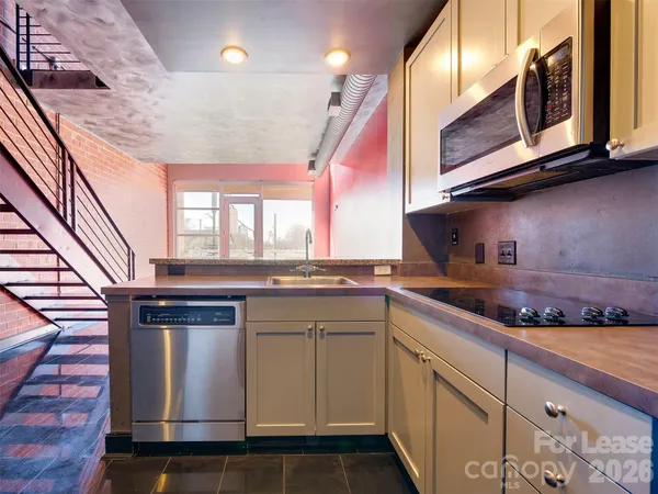a kitchen with stainless steel appliances granite countertop a stove and a sink