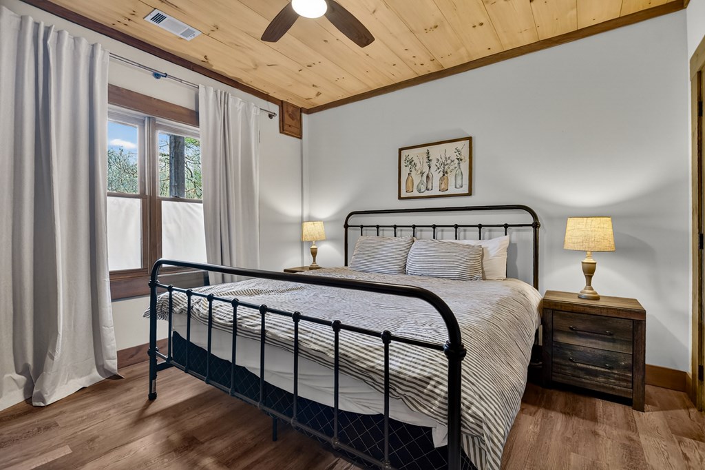 171 Cohutta Overlook Trail Blue Ridge, GA 30513 - Photo 32 of 47 a bedroom with a bed and wooden floor