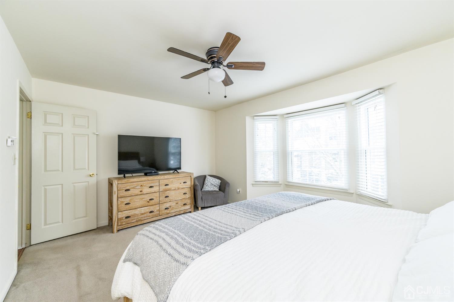 382 Waterview Road Bridgewater, NJ 08807 - Photo 17 of 30 a bedroom with a bed and a flat screen tv