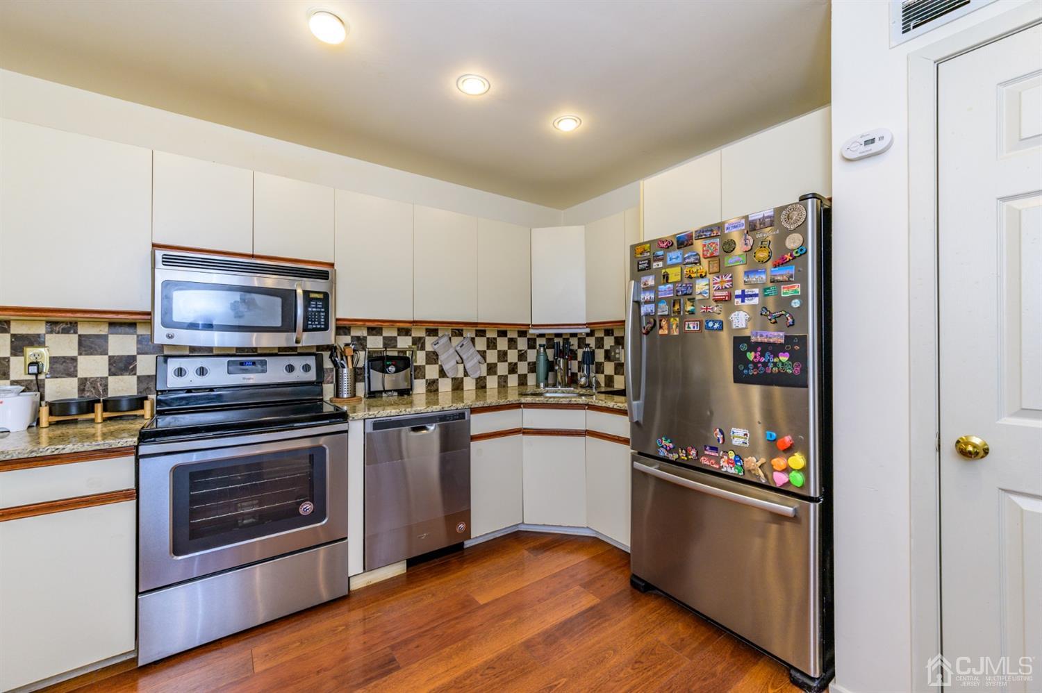 382 Waterview Road Bridgewater, NJ 08807 - Photo 8 of 30 a kitchen with granite countertop stainless steel appliances and wooden floor