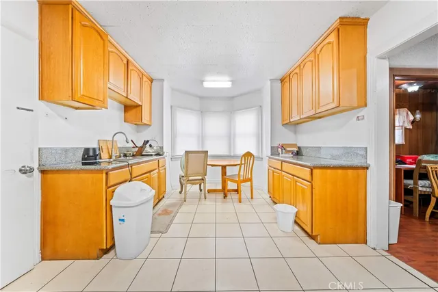 a kitchen with stainless steel appliances granite countertop a sink and cabinets