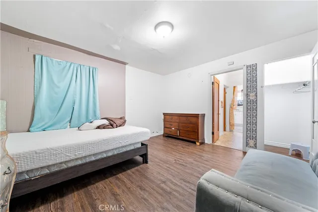 a bedroom with a bed and a couch