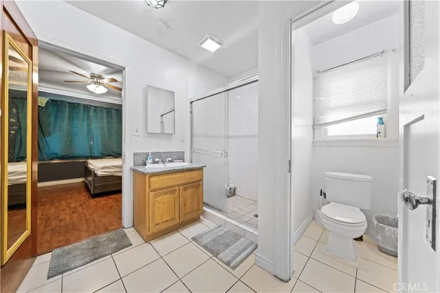 a spacious bathroom with a granite countertop sink a toilet and shower