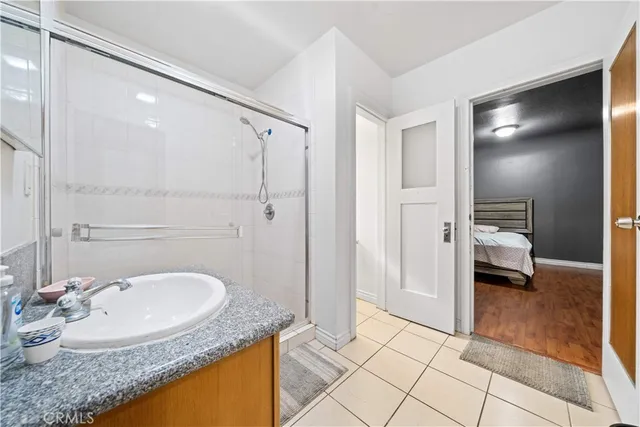 a bathroom with a granite countertop sink and a mirror