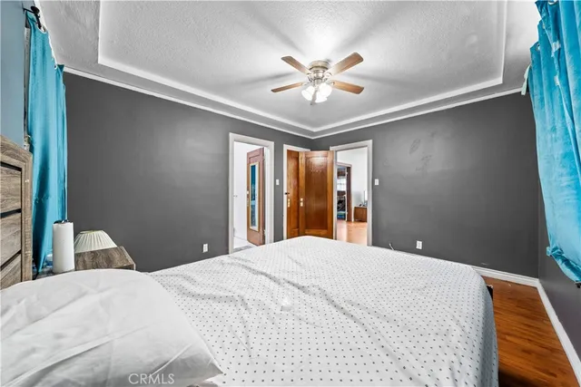 a bedroom with a large bed and a chandelier