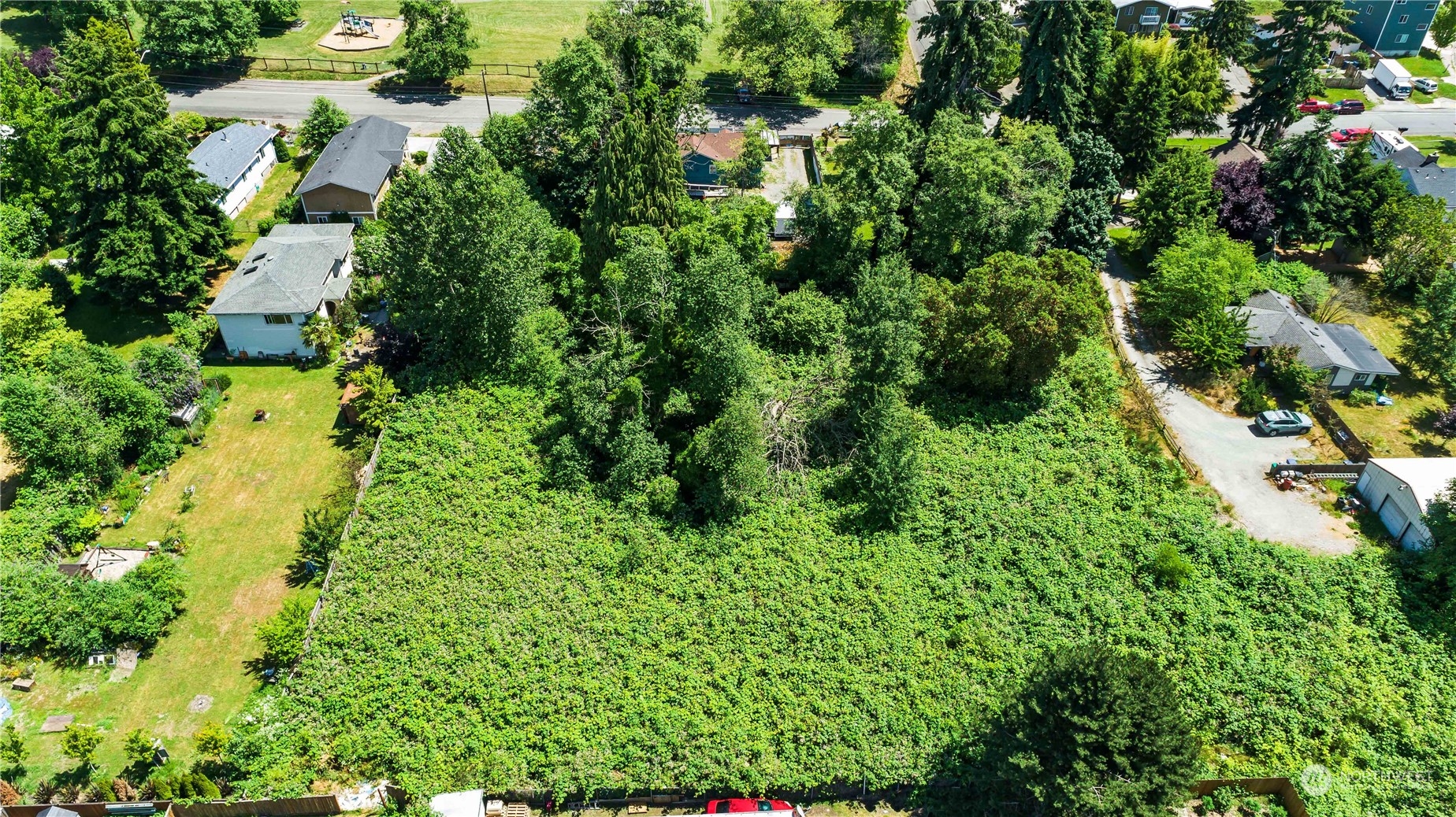 10057 24th Avenue Southwest Seattle, WA 98146 - Photo 20 of 23 an aerial view of residential house with outdoor space and trees all around