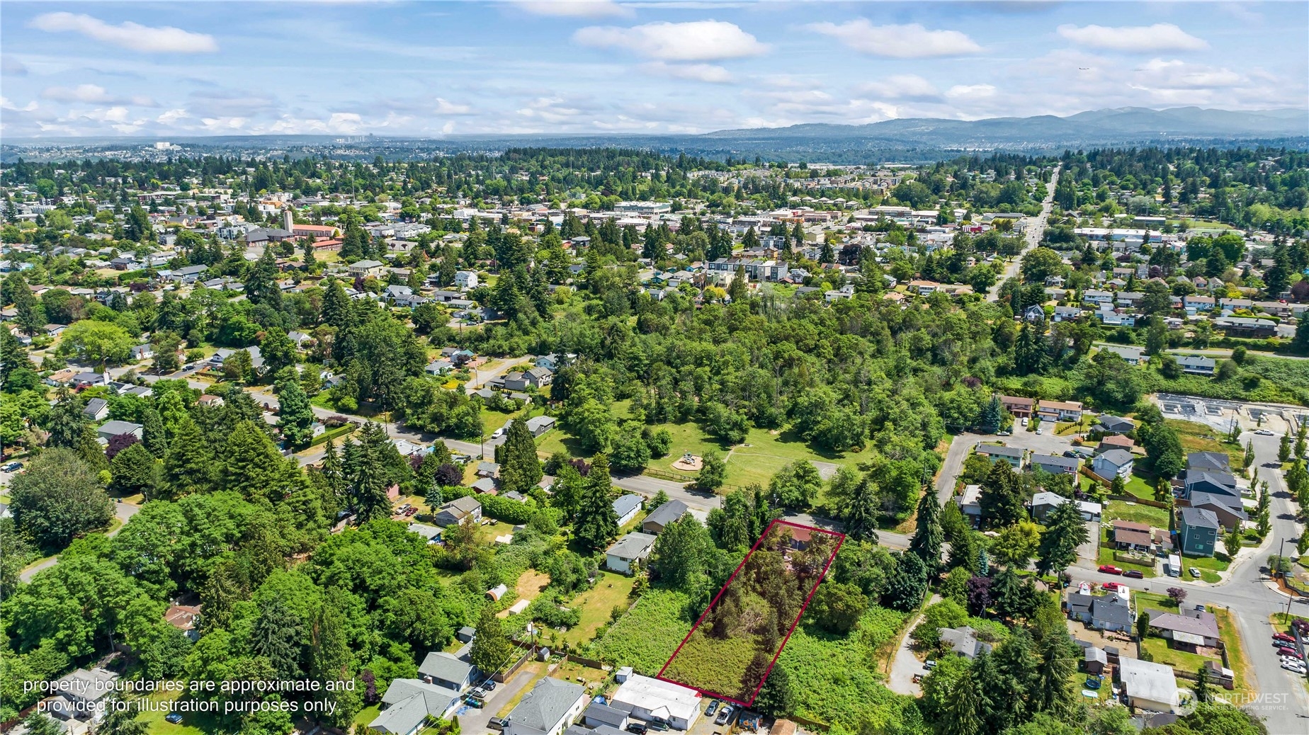10057 24th Avenue Southwest Seattle, WA 98146 - Photo 21 of 23 a view of a city with lush green forest