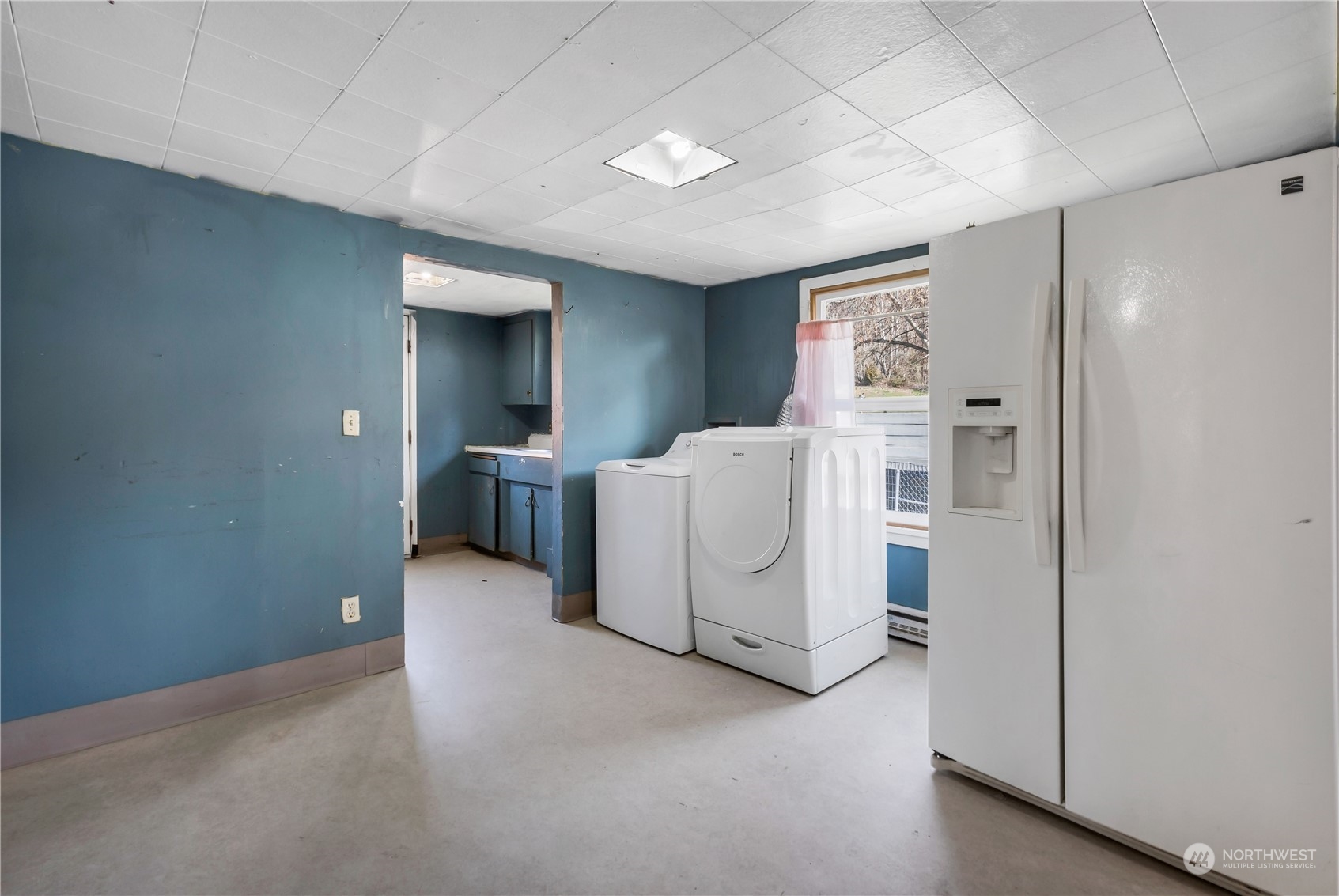 10057 24th Avenue Southwest Seattle, WA 98146 - Photo 10 of 23 a view of a storage & utility room with closet washer and dryer