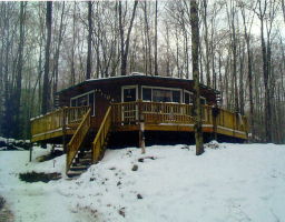 a view of outdoor space with deck and trees