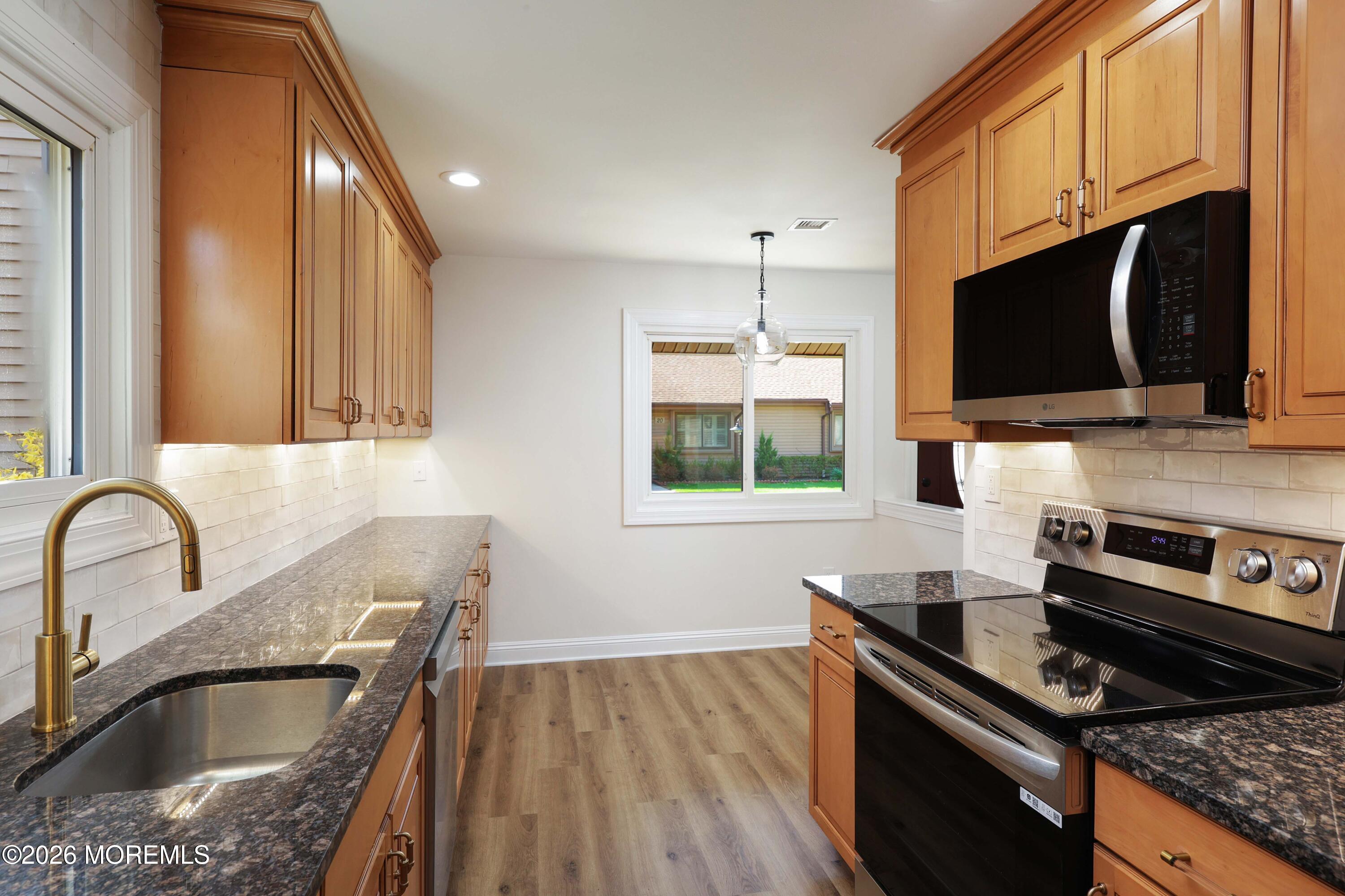 50 Hanover Court Red Bank, NJ 07701 - Photo 11 of 37 a kitchen with a stove a sink and a microwave