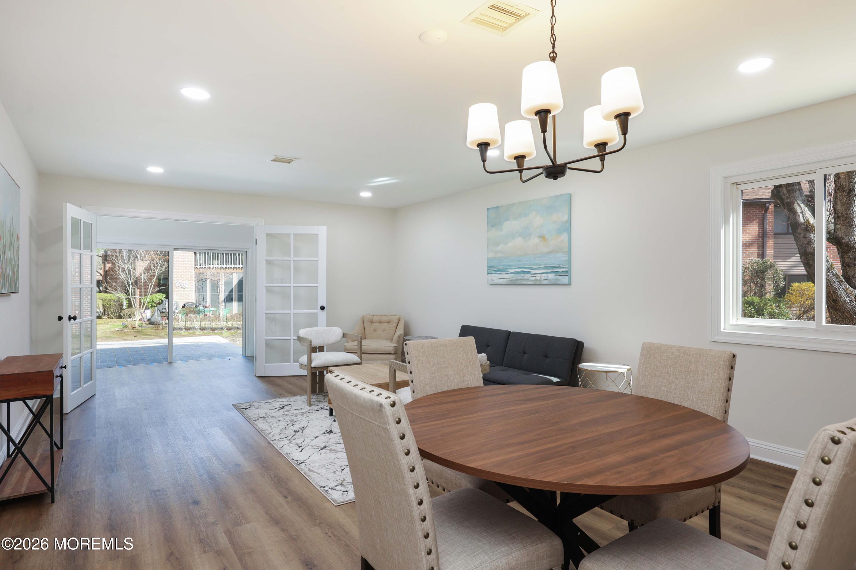 50 Hanover Court Red Bank, NJ 07701 - Photo 14 of 37 a living room with furniture a dining table and a chandelier
