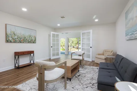 a living room with furniture and a wooden floor