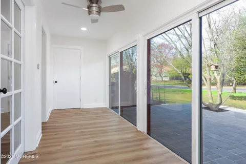 a view of a bedroom with wooden floor and balcony