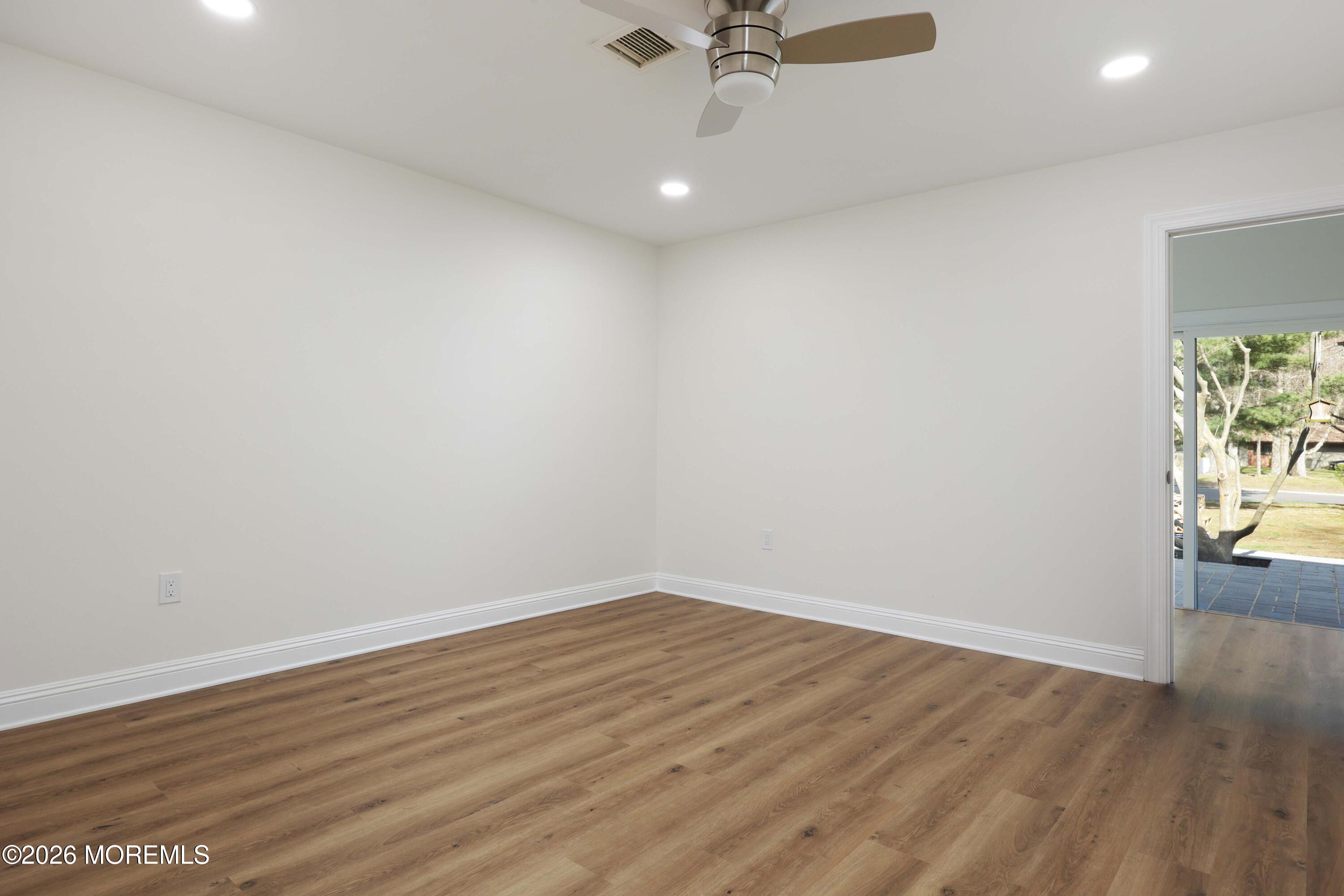 50 Hanover Court Red Bank, NJ 07701 - Photo 22 of 37 wooden floor in an empty room with a window
