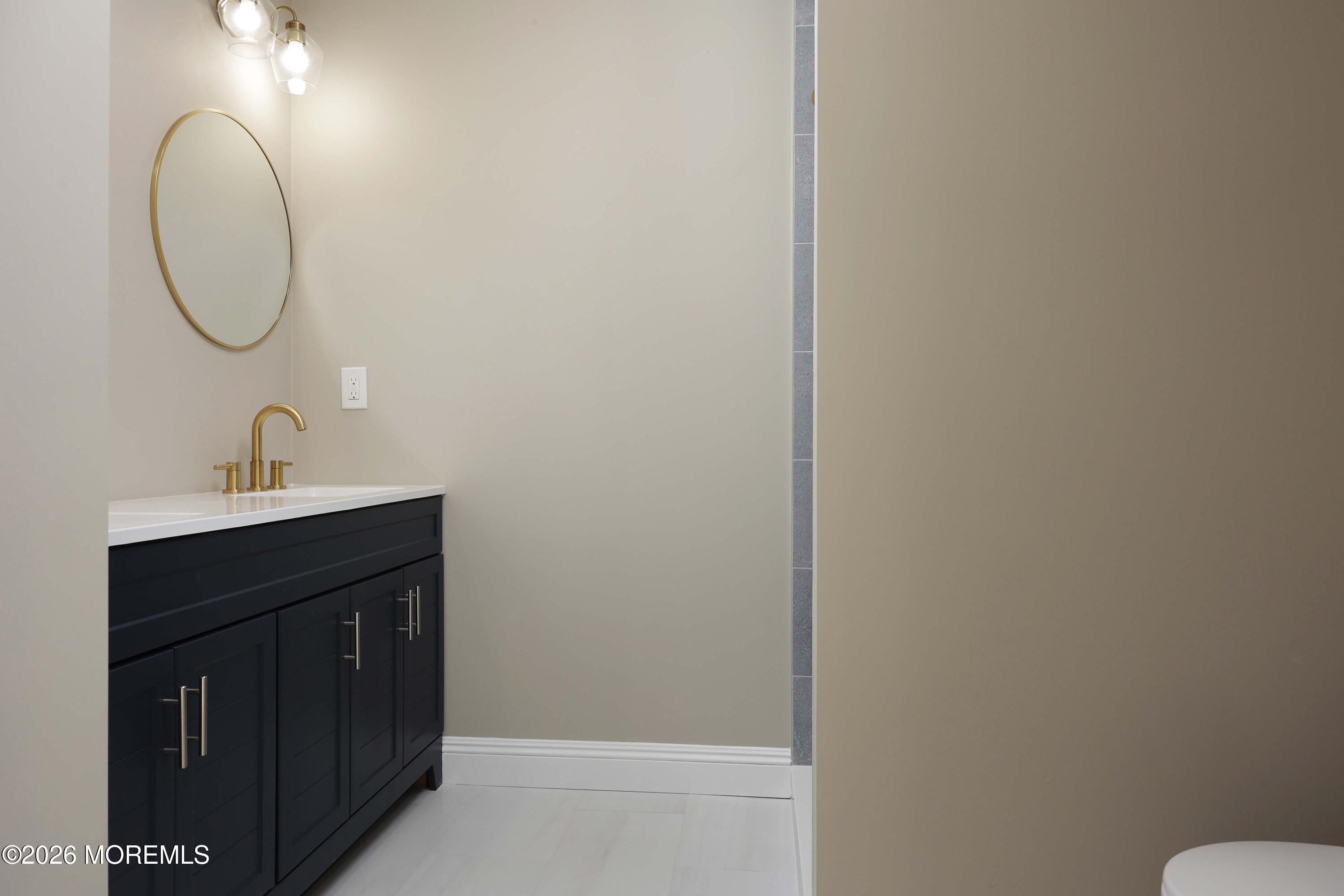 50 Hanover Court Red Bank, NJ 07701 - Photo 29 of 37 a bathroom with a sink and a mirror