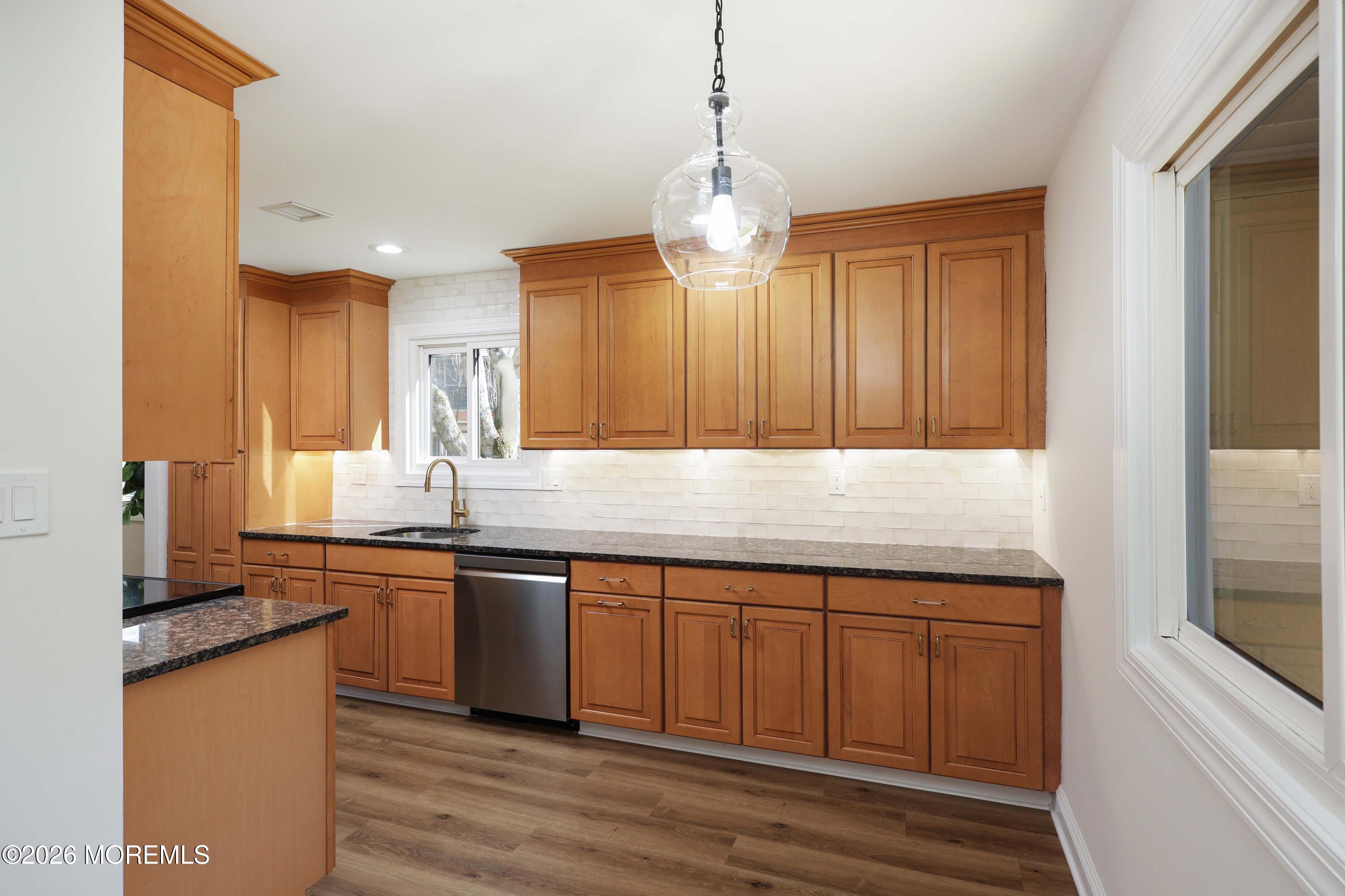 50 Hanover Court Red Bank, NJ 07701 - Photo 8 of 37 a kitchen with stainless steel appliances granite countertop wooden cabinets and a sink