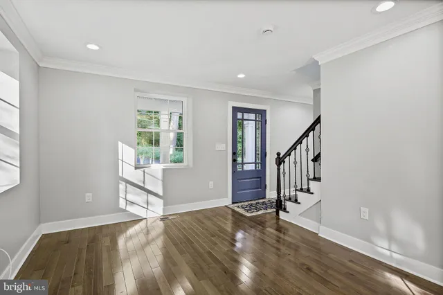a view of entryway and hall with wooden floor