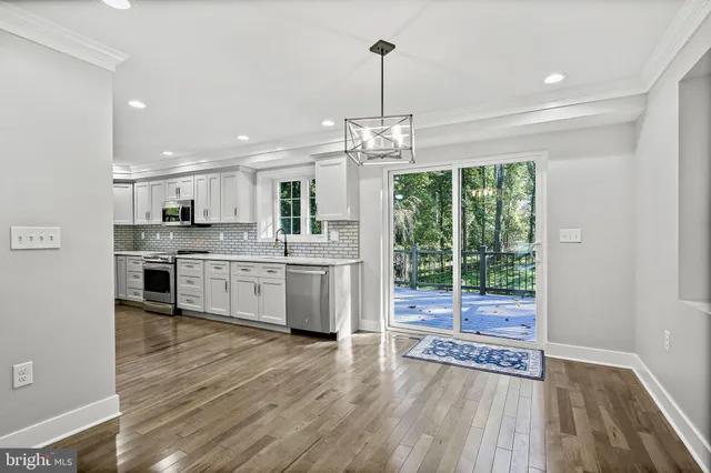 a kitchen with stainless steel appliances granite countertop a stove top oven and sink