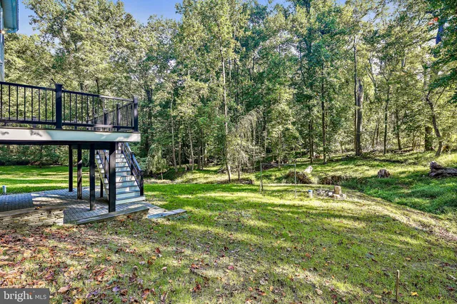 a view of a backyard with swimming pool