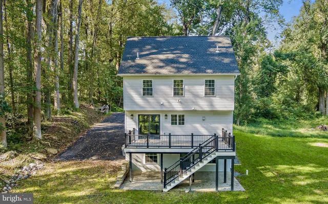 a aerial view of a house with a yard chairs and table