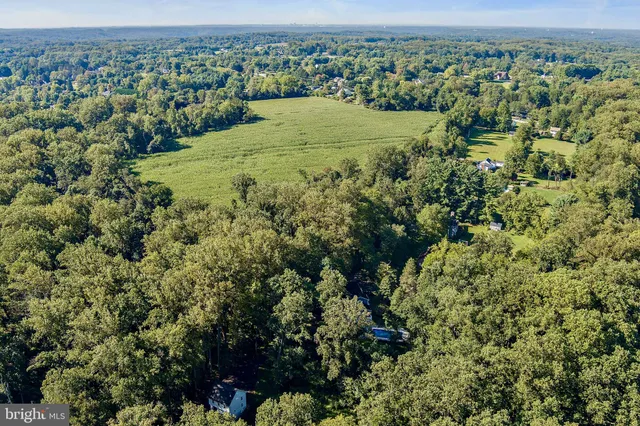 an aerial view of a houses with a yard
