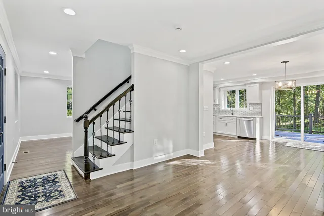 a view of entryway with wooden floor and stairs