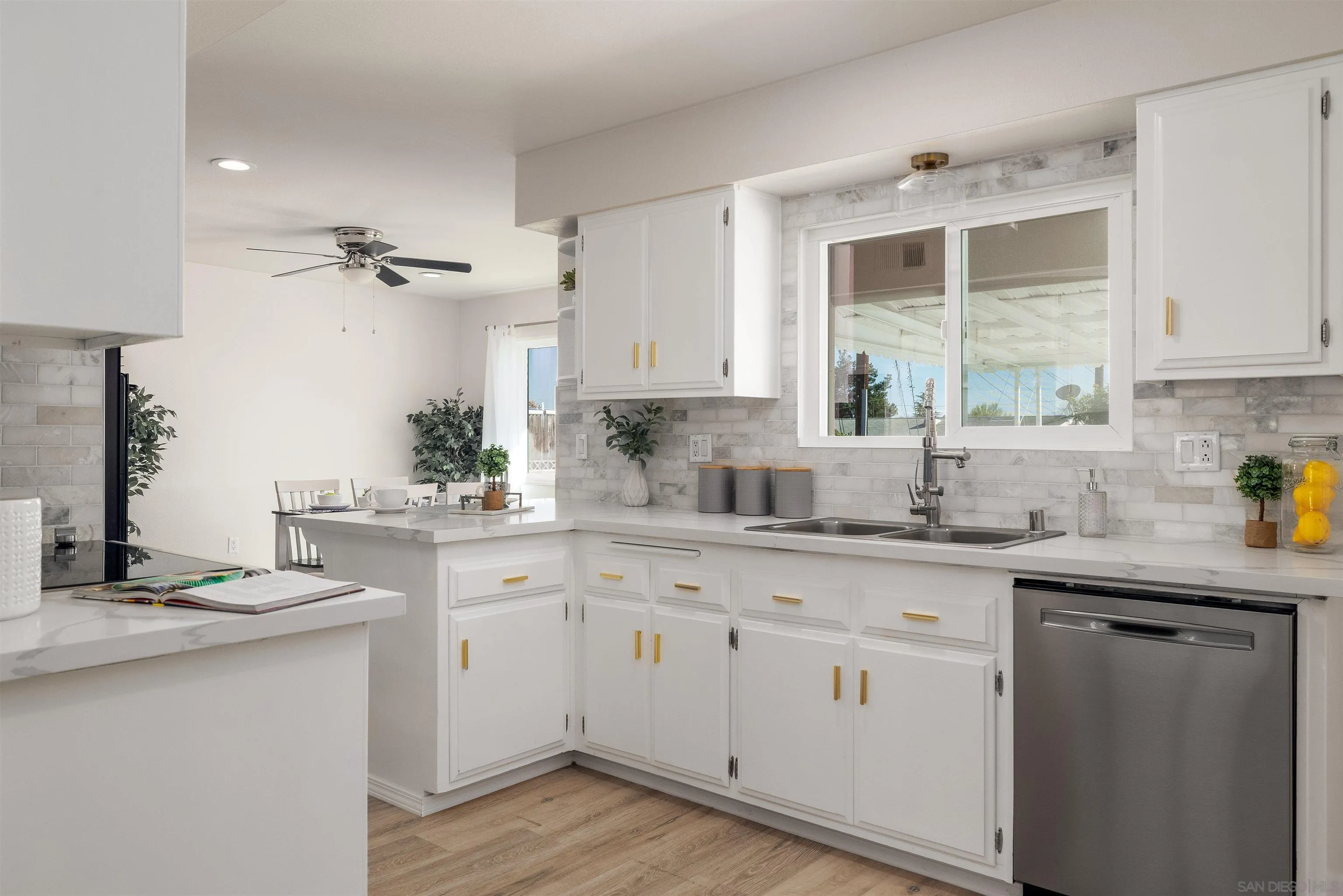 27431 El Rancho Road Menifee, CA 92586 - Photo 14 of 39 a kitchen with granite countertop white cabinets white appliances and a sink